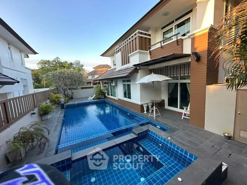 Luxurious modern home with private blue-tiled pool and elegant exterior design.