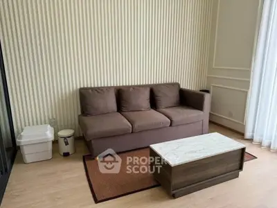 Cozy living room with brown sofa and marble coffee table, perfect for relaxation.