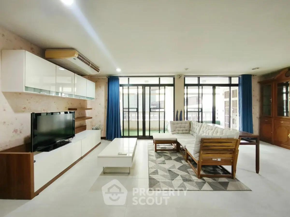 Spacious living room with modern furniture and large windows for natural light