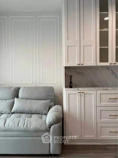 Elegant living room with plush sofa and stylish cabinetry