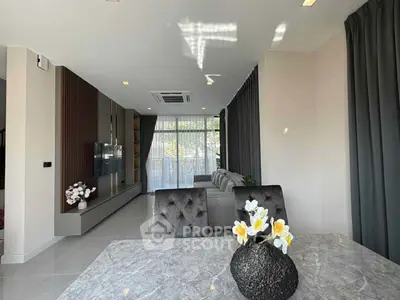 Modern living room with elegant decor, featuring a marble table and plush seating, perfect for relaxation.