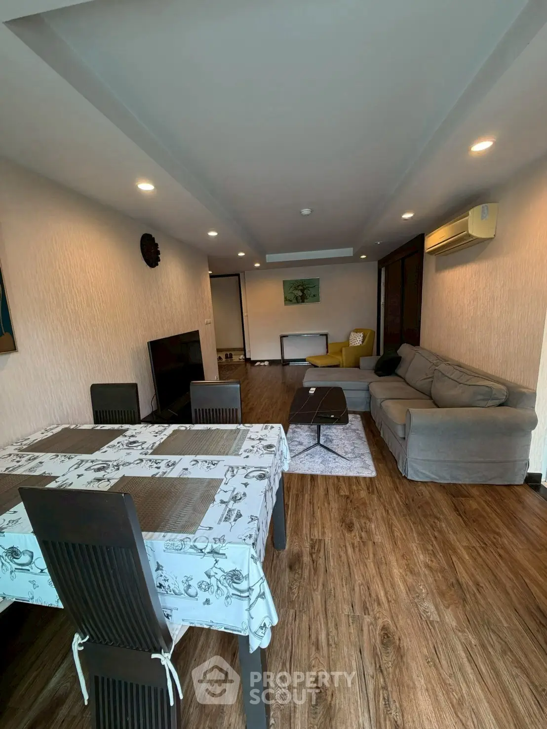 Spacious living room with modern decor and wooden flooring