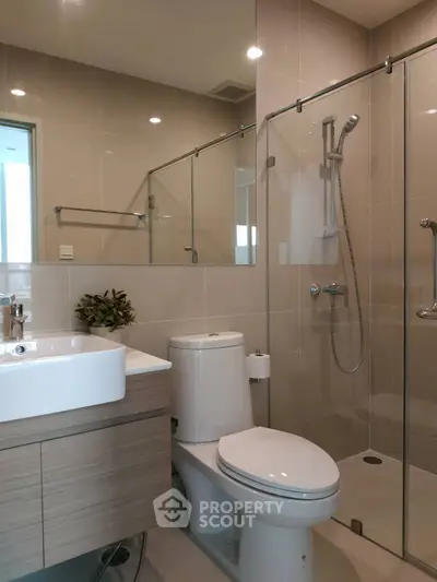 Modern bathroom with glass shower and sleek fixtures