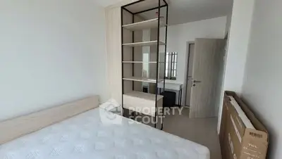 Modern bedroom with minimalist design and ample natural light.