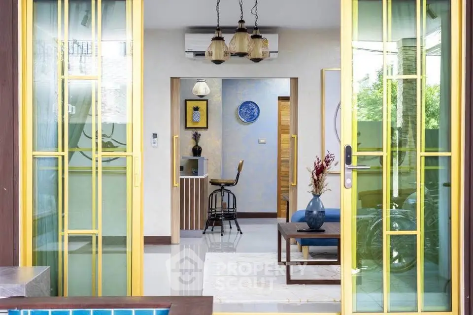 Stylish modern interior with open layout and pool view, featuring elegant decor and vibrant colors.