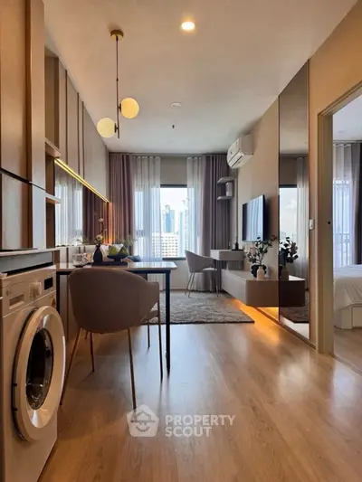 Modern living room with dining area and washing machine, featuring elegant decor and city view.
