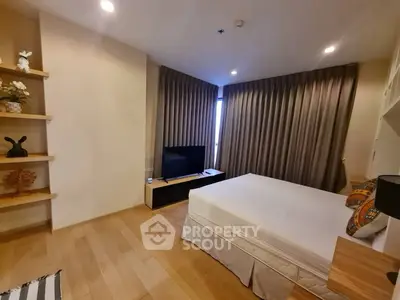 Spacious bedroom with modern decor and natural light in a stylish apartment.