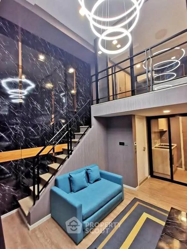 Modern duplex living room with stylish lighting and elegant staircase