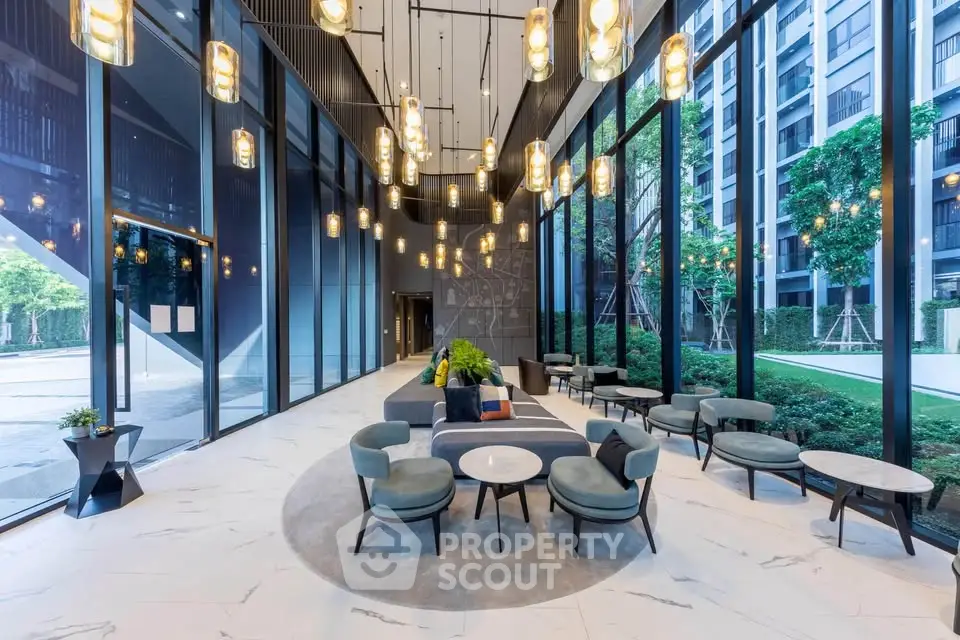 Luxurious modern lobby with elegant seating and floor-to-ceiling windows offering garden views.