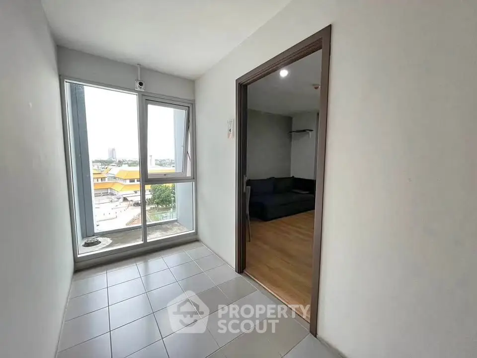 Modern apartment with tiled entryway and spacious living room view.