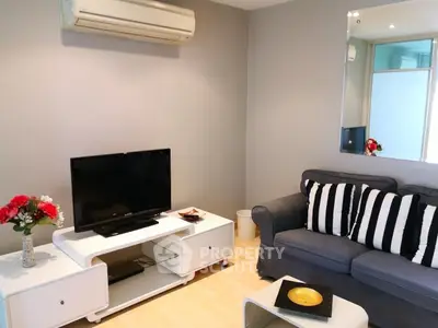 Modern living room with sleek furniture and air conditioning, perfect for relaxation.