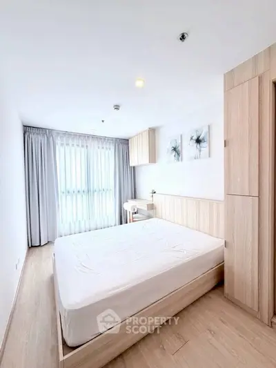 Bright and modern bedroom with minimalist design and large window.