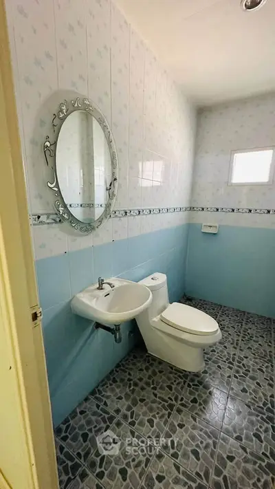 Charming bathroom with elegant oval mirror and modern fixtures