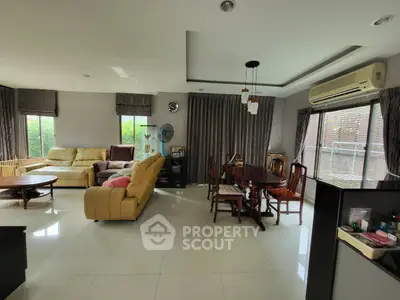 Spacious living and dining area with modern furnishings and large windows