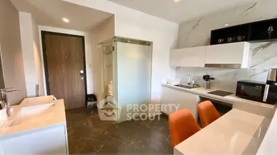 Modern kitchen with sleek design, marble countertops, and integrated appliances in a stylish apartment.