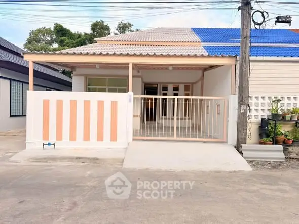 Charming single-story home with a gated entrance and modern facade, perfect for cozy living.