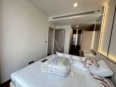 Modern bedroom with sleek design and ample natural light, featuring a comfortable bed and stylish decor.