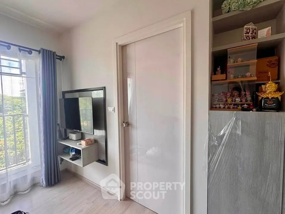 Modern living room with wall-mounted TV and decorative shelving