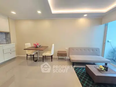 Modern living room with sleek furniture and open kitchen layout, perfect for stylish urban living.