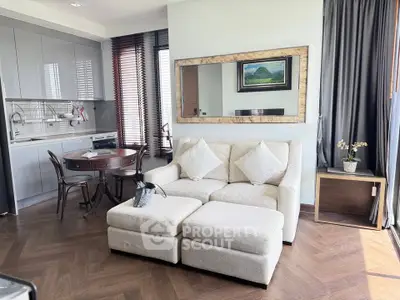 Modern living room with cozy sofa, elegant kitchen, and stylish decor in a bright open space.