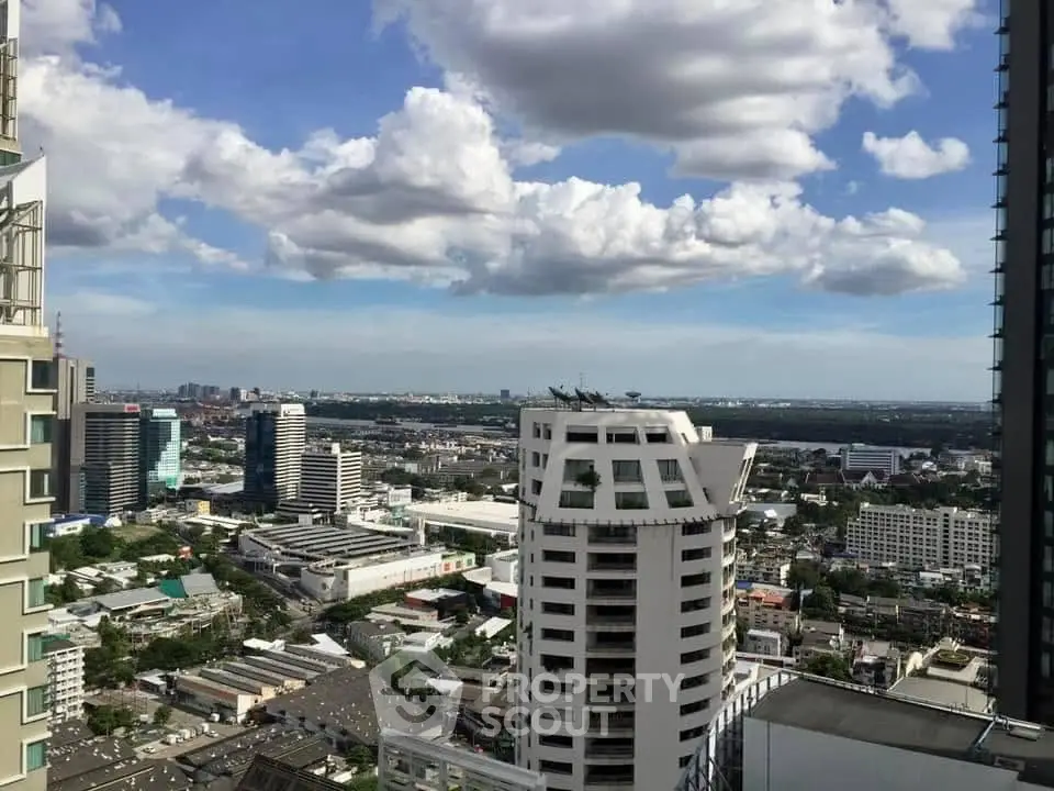 Stunning cityscape view from a high-rise building showcasing urban skyline and expansive sky.
