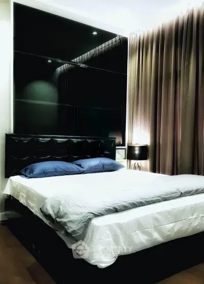 Luxurious bedroom with elegant decor and ambient lighting, featuring a plush bed and stylish curtains.
