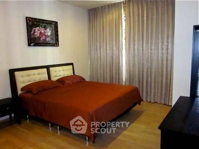 Spacious bedroom with elegant decor and natural light