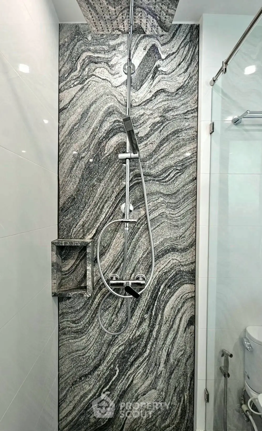 Luxurious modern bathroom with elegant marble shower design and sleek fixtures.