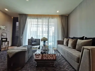 Luxurious living room with elegant decor and large windows for natural light.