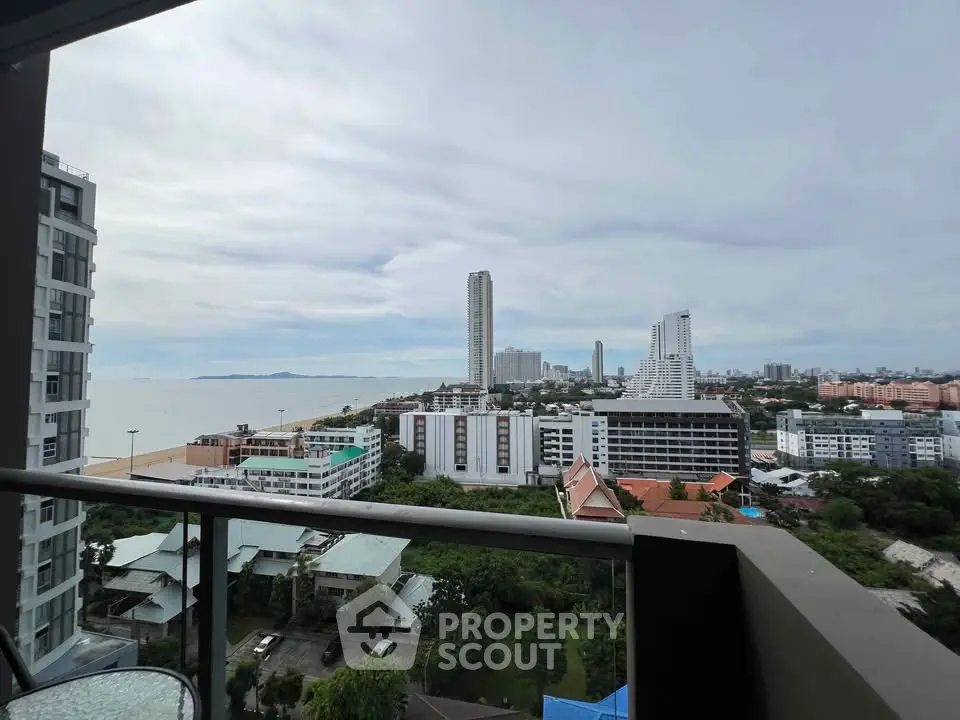 Stunning high-rise balcony view of cityscape and ocean horizon, perfect for urban living.