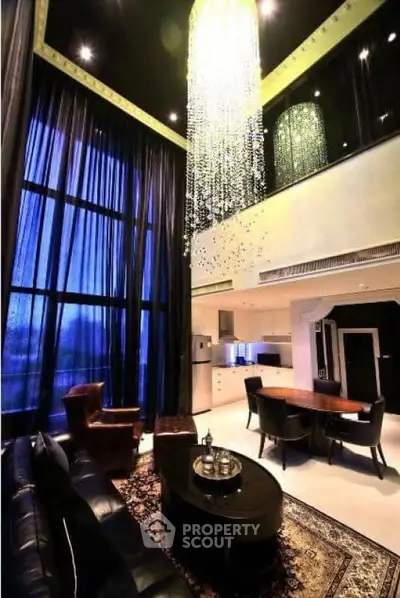 Luxurious modern living room with high ceilings and elegant chandelier