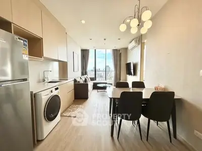 Modern open-plan kitchen and living area with city view, featuring sleek appliances and stylish dining setup.