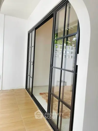 Modern balcony with sleek sliding glass doors and tiled flooring