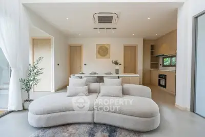 Modern living room with stylish sofa and open kitchen layout
