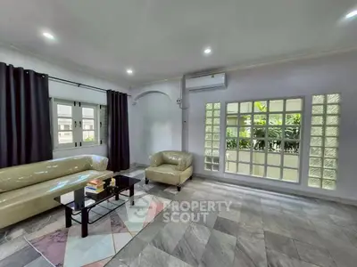 Spacious living room with modern furniture and large windows for natural light.