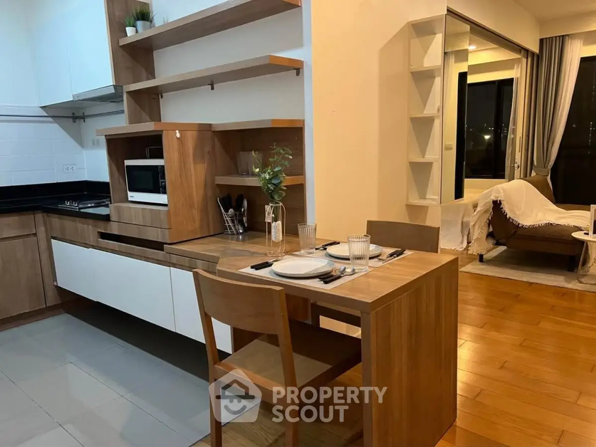 Modern kitchen with wooden dining set and open layout to living room
