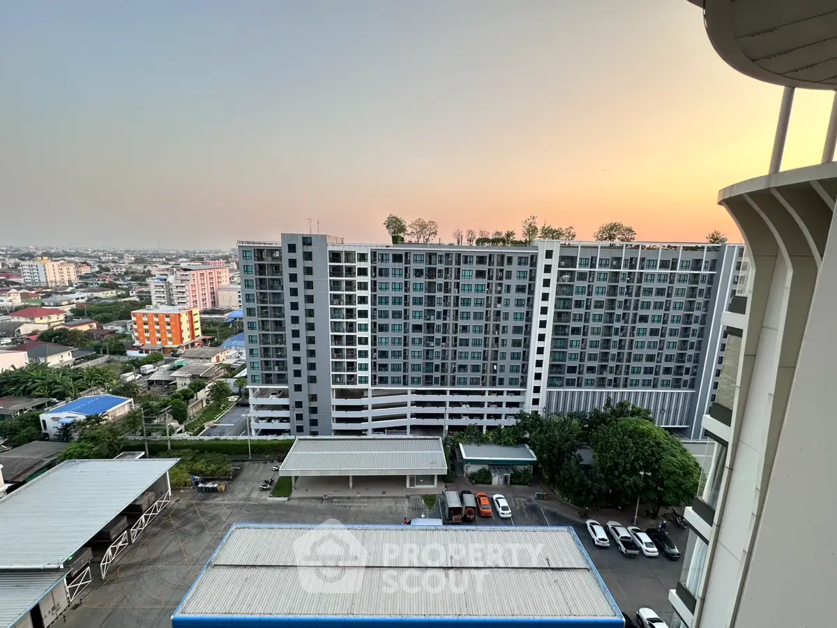 Stunning cityscape view from high-rise building at sunset, showcasing modern urban living.