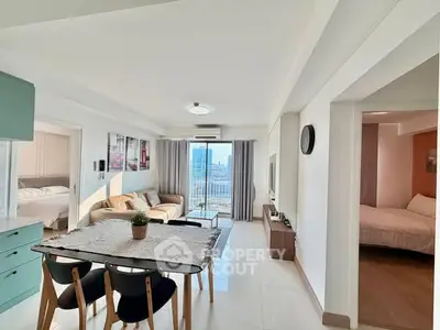 Spacious modern living room with dining area and city view, perfect for urban living.