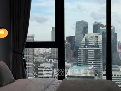 Luxurious bedroom with stunning city skyline view through large windows, perfect for urban living.