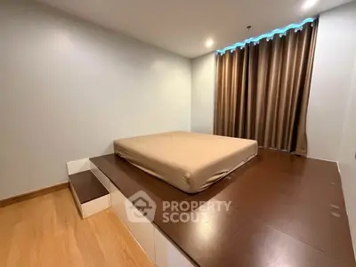 Modern minimalist bedroom with platform bed and wooden flooring