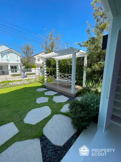 Charming garden with pergola and stepping stones in modern residential area