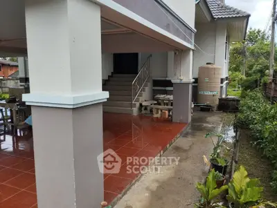 Charming exterior view of a modern home with spacious covered patio and lush greenery.
