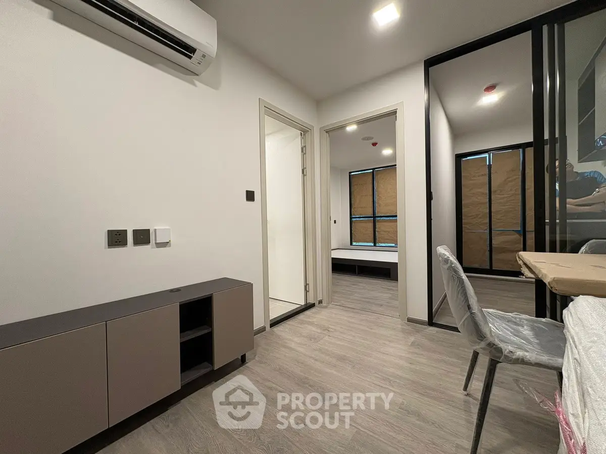 Modern apartment interior with sleek design and air conditioning, featuring a cozy living space and stylish flooring.