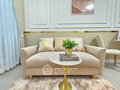 Elegant living room with plush sofa, stylish decor, and cozy ambiance.