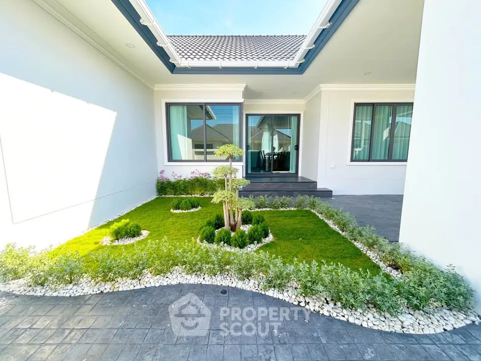 Modern home exterior with landscaped garden and stylish entrance