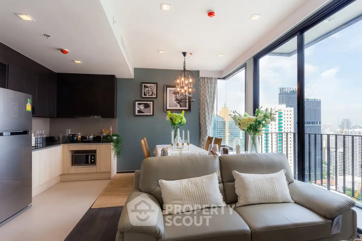 Luxurious open-plan living room with stunning city view and modern kitchen.