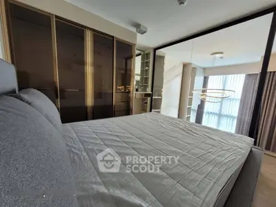 Modern bedroom with sleek design and mirrored wardrobe doors