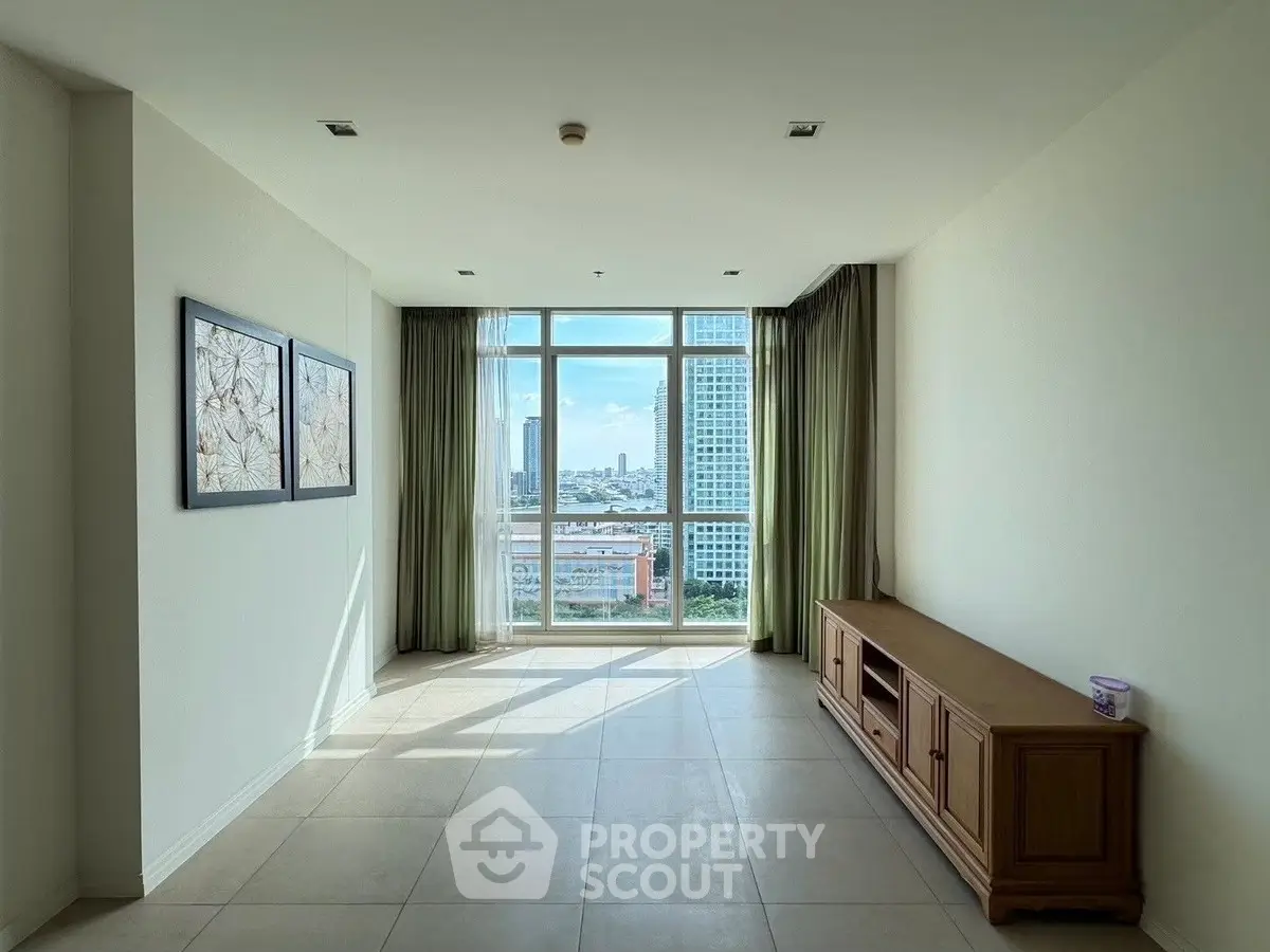 Spacious living room with large window offering stunning city view, perfect for modern urban living.