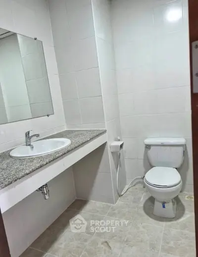 Modern bathroom with sleek fixtures and neutral tiles, perfect for a contemporary home.
