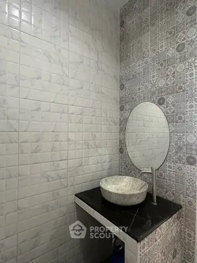 Modern bathroom with stylish sink and patterned tiles